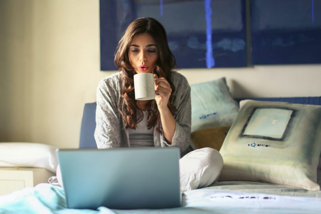 Relaxed female sitting on a bed