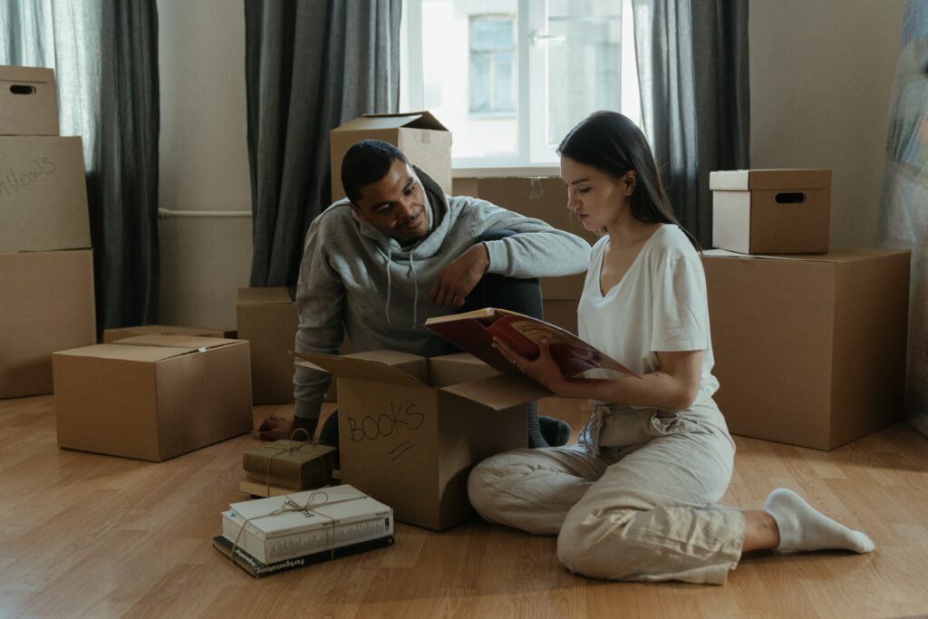 Male and female tidying up with storage boxes