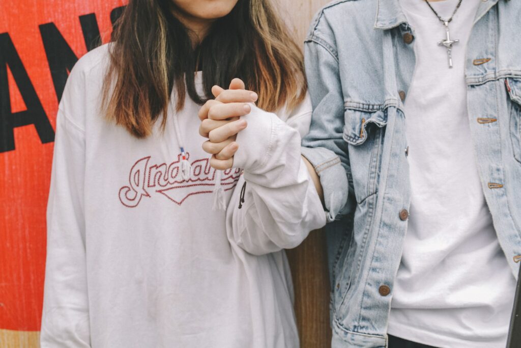 Couple holding hands in trendy clothing