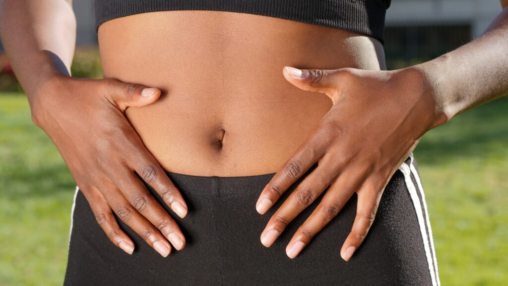 Black female touching abdomen area