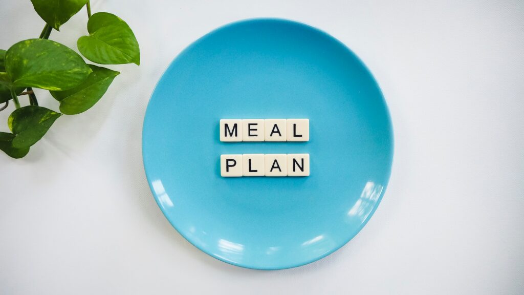 Meal plan letters laid out on a blue plate