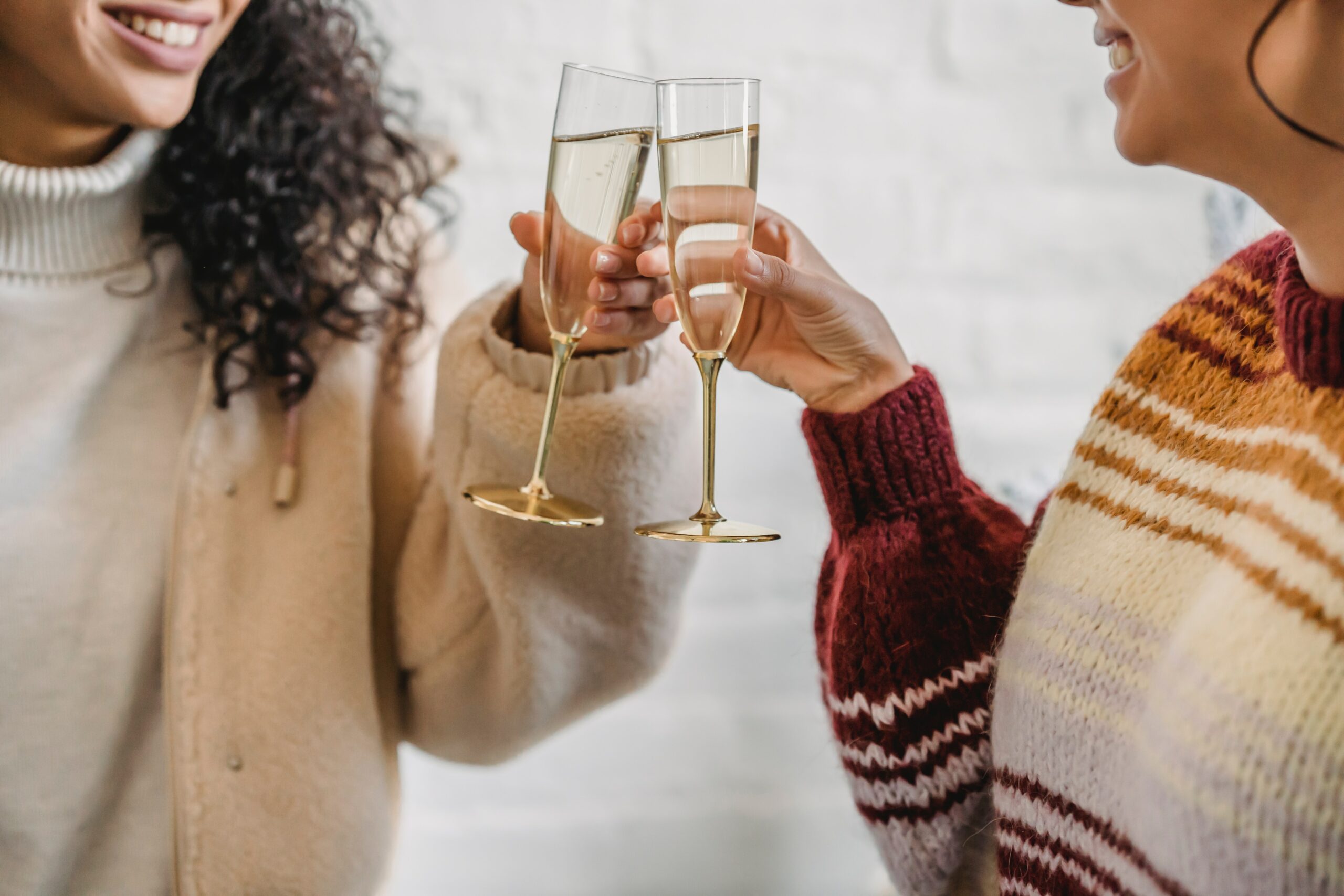 Two females toasting with a glass of prosecco