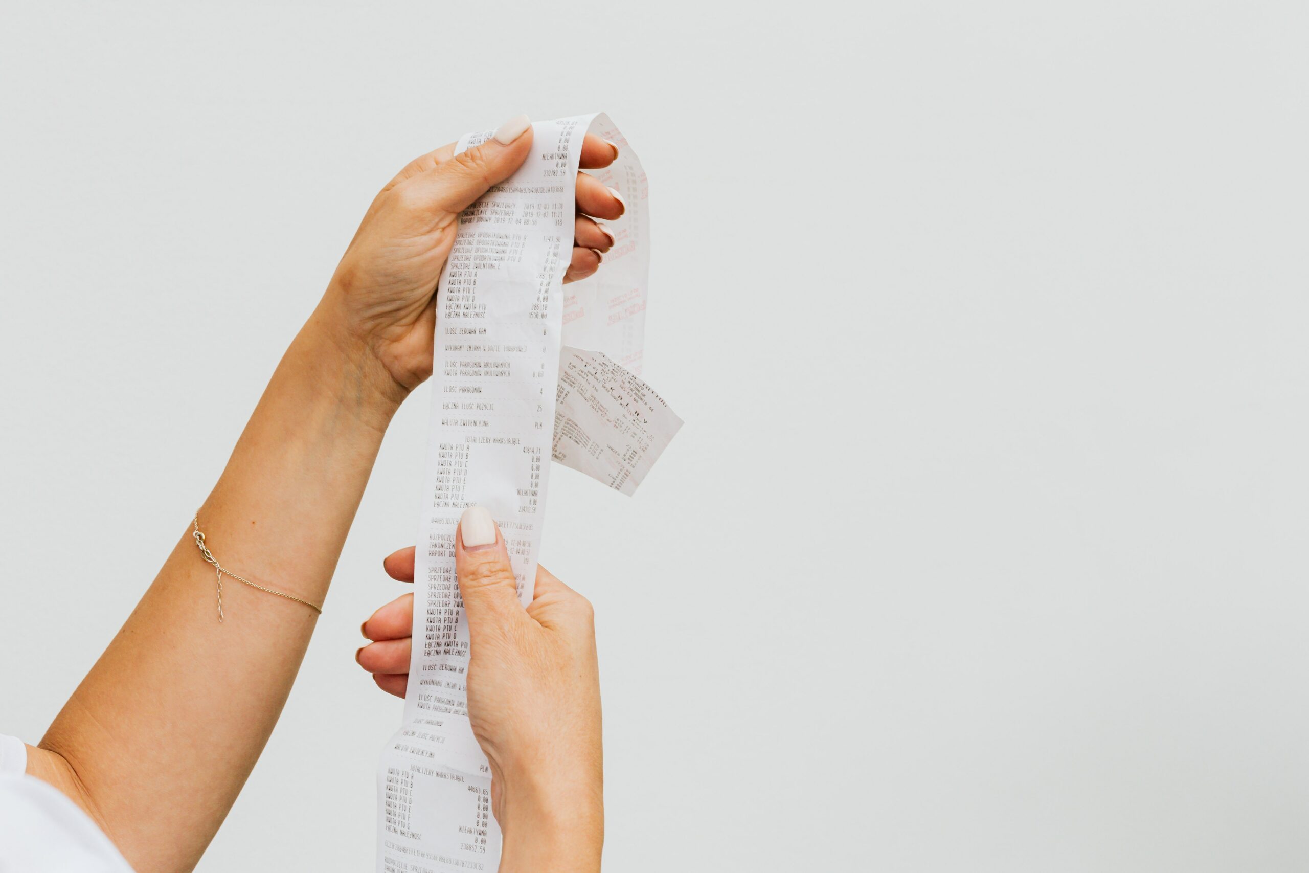 Female looking at a shopping receipt