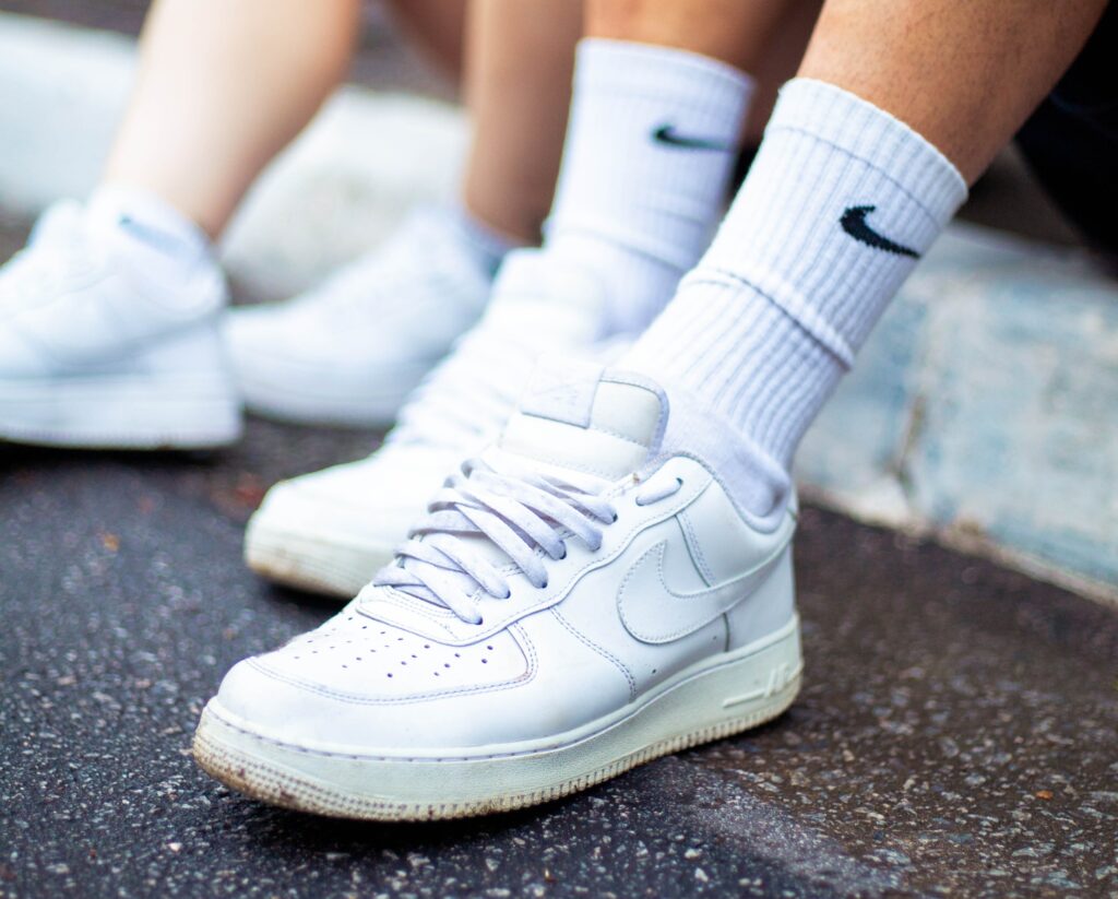 Male wearing Nike Air Force 1's in white with white crew socks