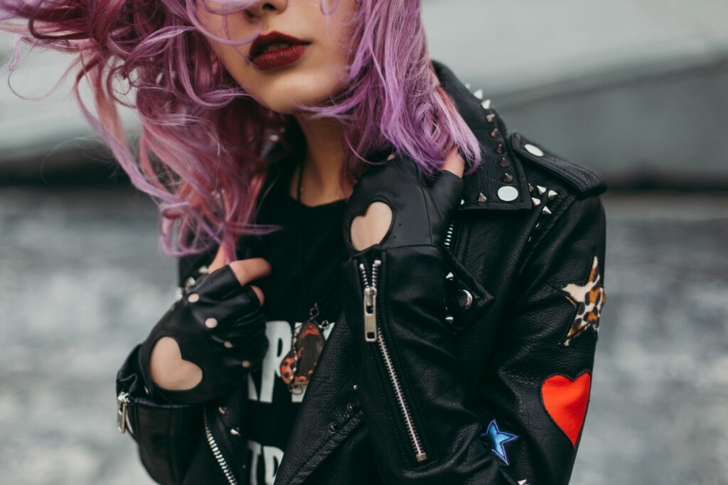Rock chick inspired leather jacket on female with purple hair