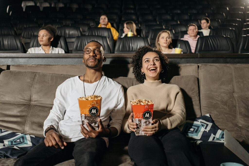 Man and woman at the cinema with popcorn